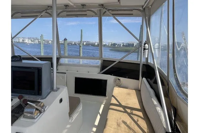 Slide: The Image of Interior view of 1989 Topaz 44 Sportfisherman boat with scenic waterfront backdrop. - 11