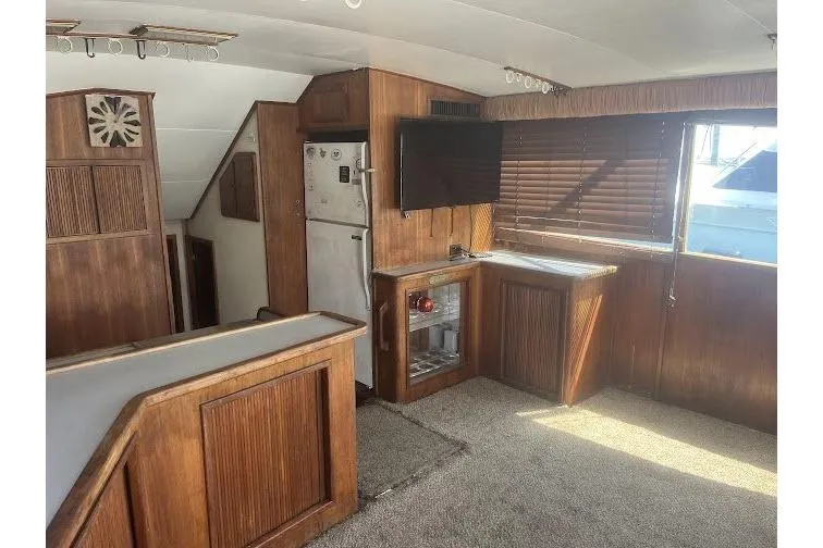 Slide: The Image of Interior of 1989 Topaz 44 Sportfisherman yacht with wood paneling and modern amenities. - 13