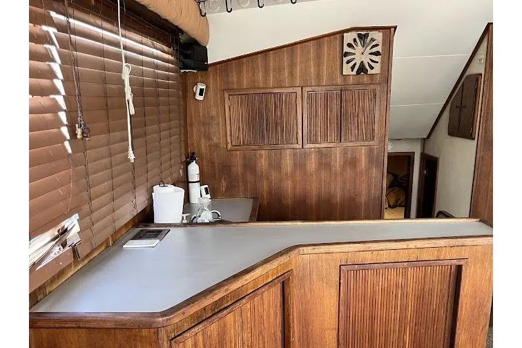 Slide: The Image of 1989 Topaz 44 Sportfisherman interior with wood paneling and counter. - 14