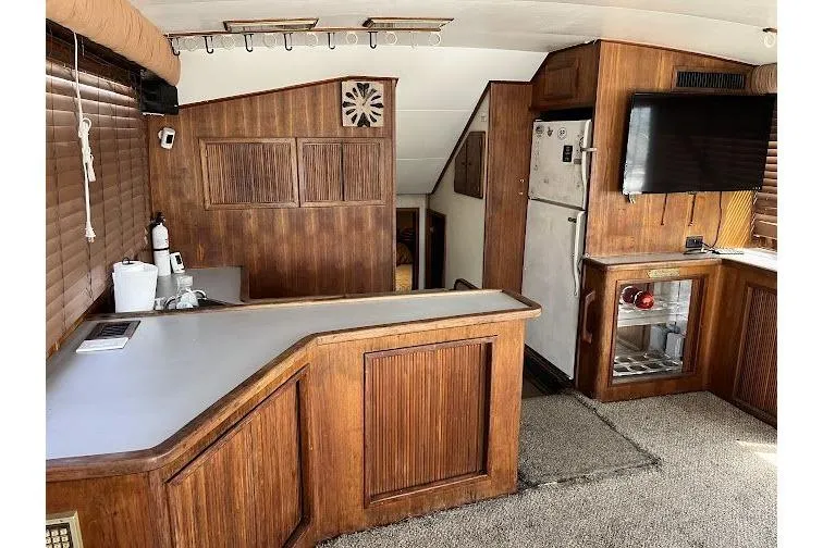 Slide: The Image of Interior of 1989 Topaz 44 Sportfisherman with wood paneling and modern amenities. - 16