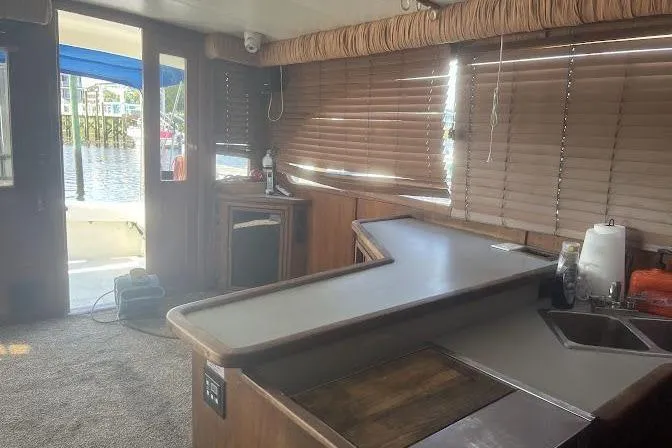 Slide: The Image of Interior of 1989 Topaz 44 Sportfisherman yacht with wooden cabinetry and waterfront view. - 18