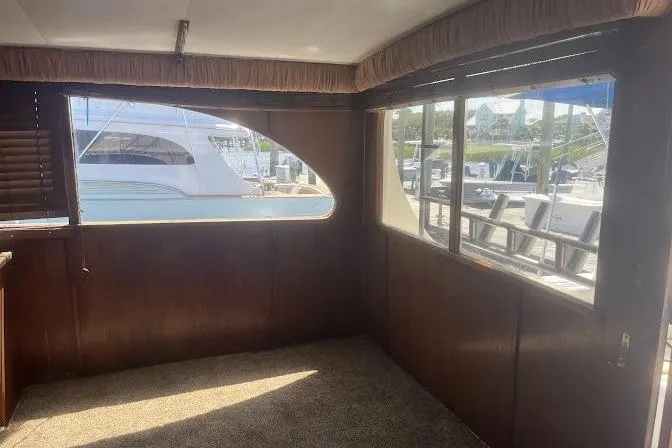 Slide: The Image of Interior view of 1989 Topaz 44 Sportfisherman yacht with wooden paneling and large windows. - 20
