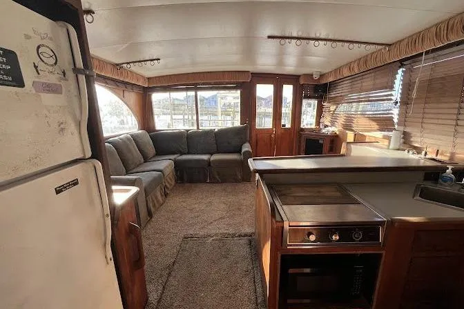 Slide: The Image of Interior of 1989 Topaz 44 Sportfisherman yacht with cozy seating and kitchen area. - 21