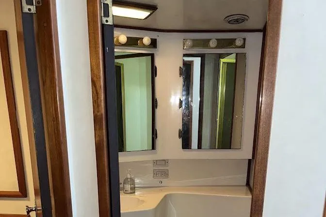 Slide: The Image of Bathroom vanity with mirrors and lights on a 1989 Topaz 44 Sportfisherman yacht. - 22