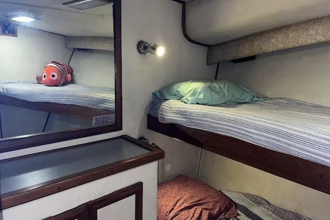 Slide: The Image of Cozy cabin interior of 1989 Topaz 44 Sportfisherman with bunk beds and nautical decor. - 24