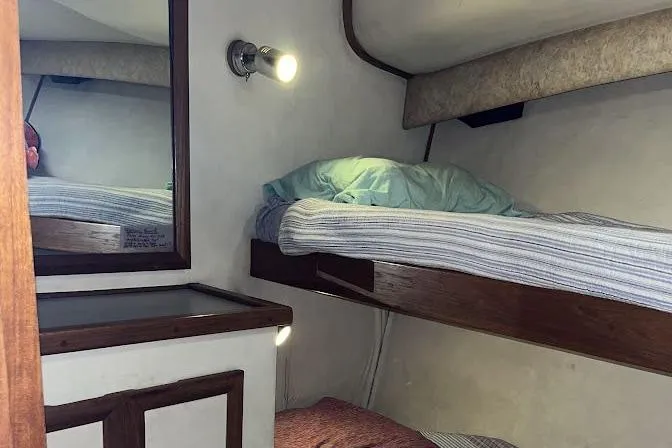 Slide: The Image of Interior cabin of 1989 Topaz 44 Sportfisherman with bunk beds and wall light. - 25