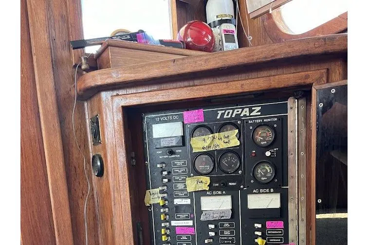 Slide: The Image of Control panel of a 1989 Topaz 44 Sportfisherman boat with gauges and labels. - 28