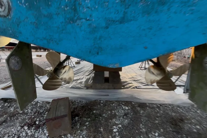 Slide: The Image of 1989 Topaz 44 Sportfisherman boat propellers and rudders, dry docked for maintenance. - 31