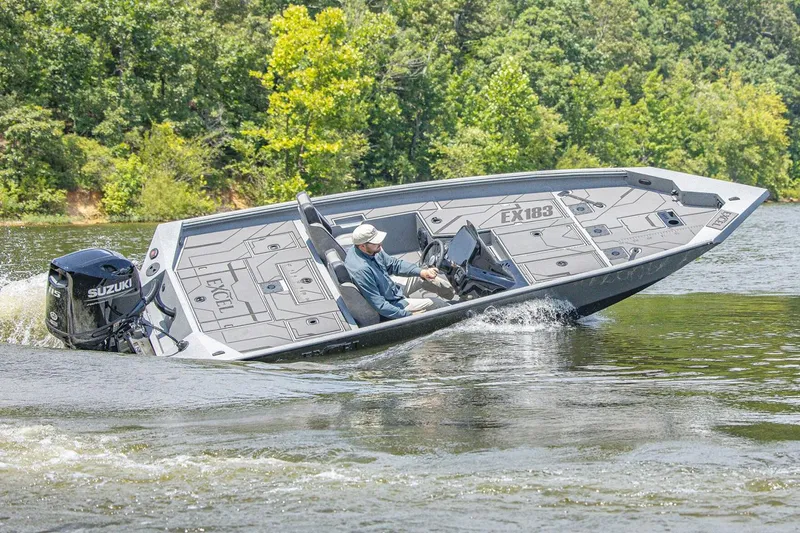 The Image of Manufacturer Provided Image: 2026 Excel EX 183 boat cruising on a lake with lush green trees. - 0