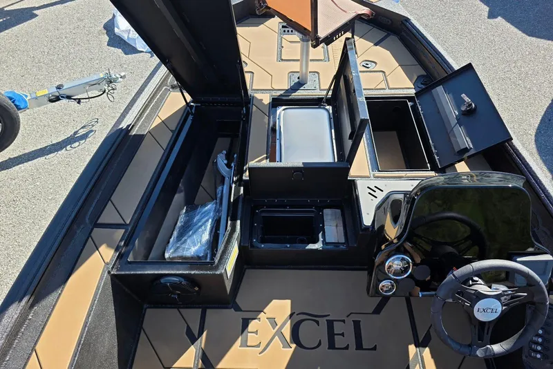 Slide: The Image of 2026 Excel EX 183 boat interior with open storage compartments and steering wheel. - 16