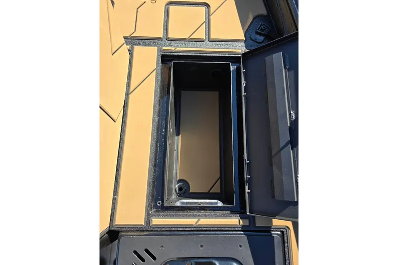 Slide: The Image of Open storage compartment on 2026 Excel EX 183 boat, featuring tan and black design. - 19