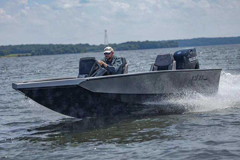 Slide: The Image of Manufacturer Provided Image: 2026 Excel EX 183 boat cruising on a lake with a driver. - 2