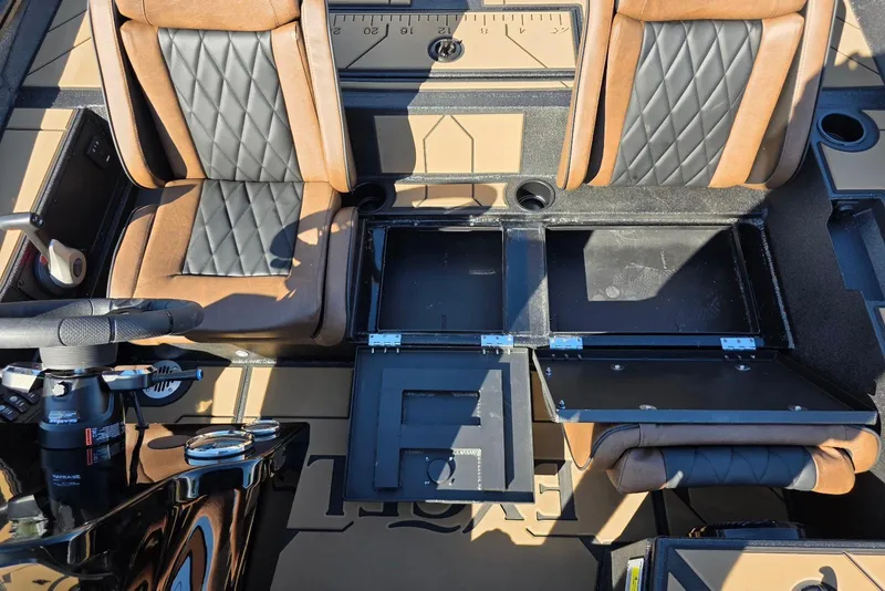 Slide: The Image of Interior of 2026 Excel EX 183 boat with brown and black seating and storage compartments. - 27