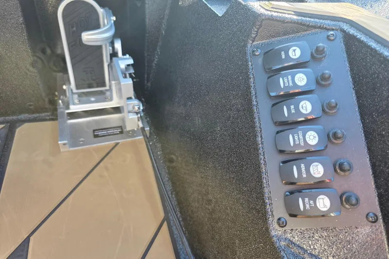 Slide: The Image of Control panel and foot pedal in 2026 Excel EX 183 boat cockpit. - 31