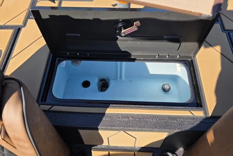 Slide: The Image of Open storage compartment in Excel EX 183 boat, 2026 model, with tan and black interior. - 35