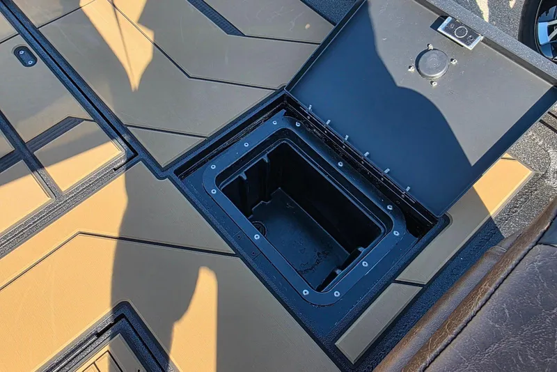 Slide: The Image of Open storage compartment on Excel EX 183 boat, 2026 model, with tan and black interior. - 36