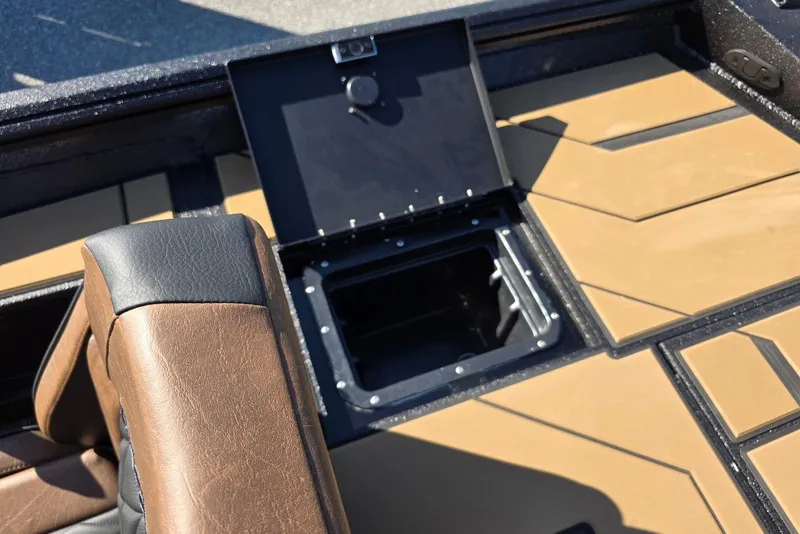 Slide: The Image of Open storage compartment on Excel EX 183 boat, 2026 model, with brown and black seating. - 37
