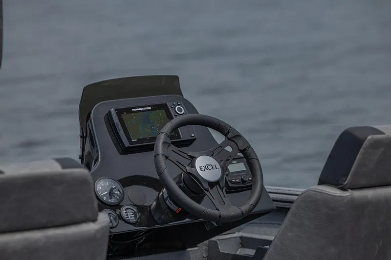 Slide: The Image of Manufacturer Provided Image: Steering console of 2026 Excel EX 183 boat with navigation display on calm water. - 5