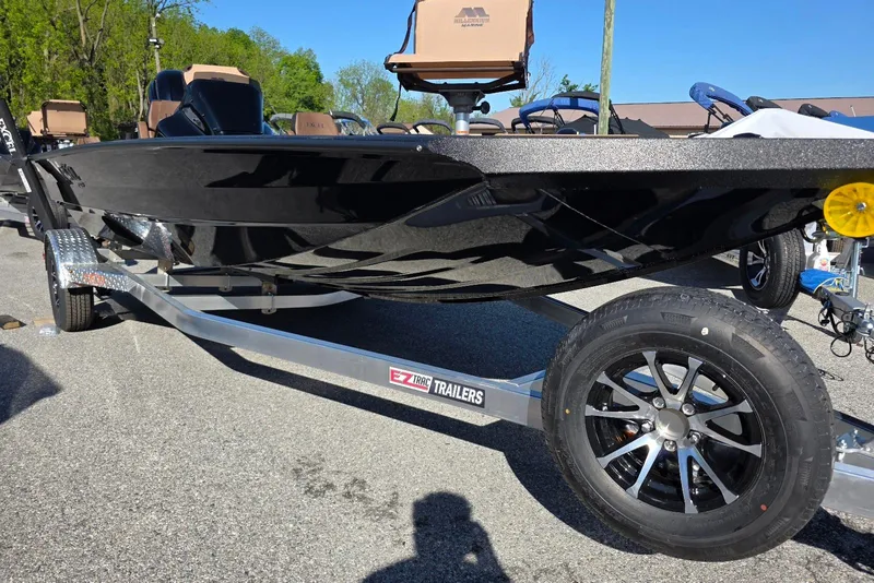 Slide: The Image of 2026 Excel EX 183 boat on EZ Trac trailer, parked outdoors. - 8