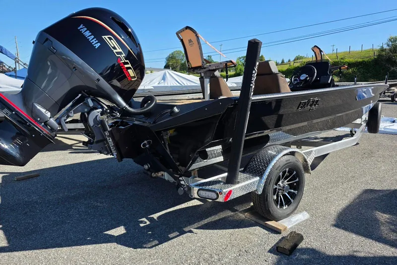Slide: The Image of 2026 Excel EX 183 boat with Yamaha engine on a trailer, parked outdoors. - 9