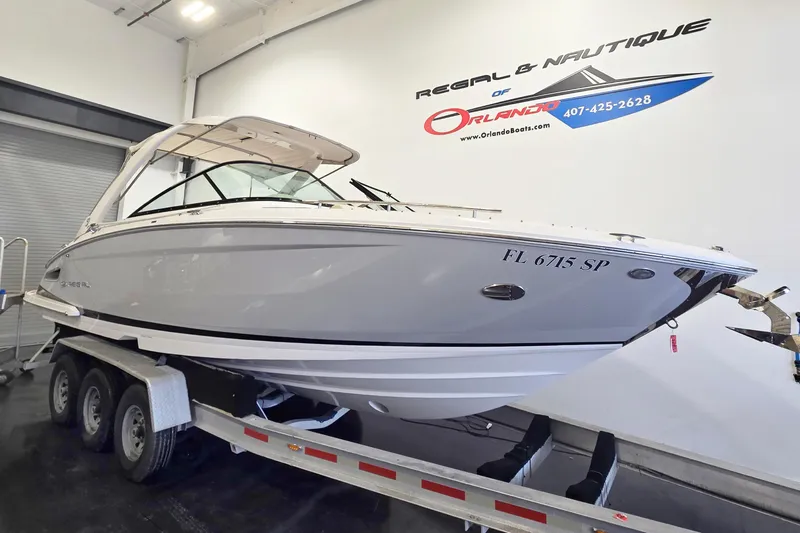 The Image of 2020 Regal 2800 Bowrider boat on trailer in showroom, Orlando dealership. - 1