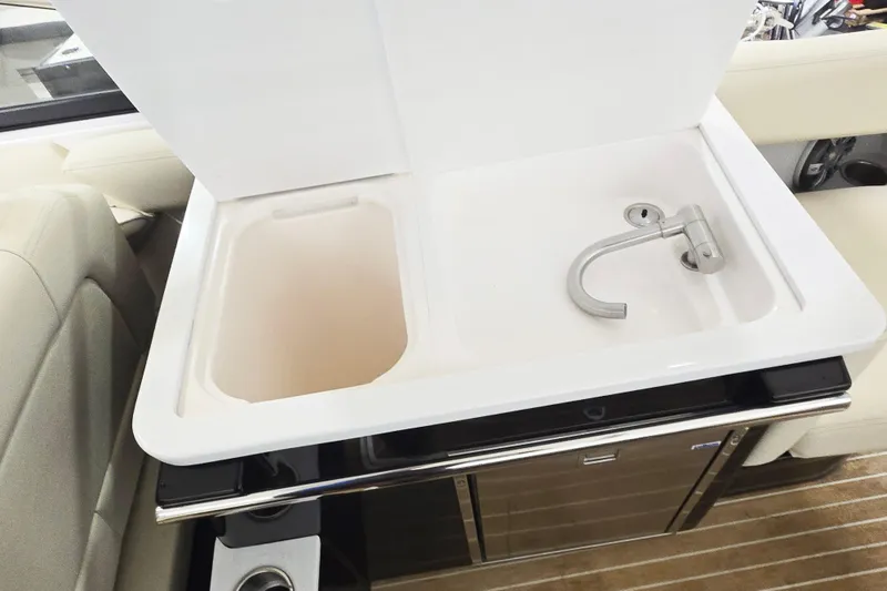 Slide: The Image of 2020 Regal 2800 Bowrider boat sink with modern faucet and storage area. - 11