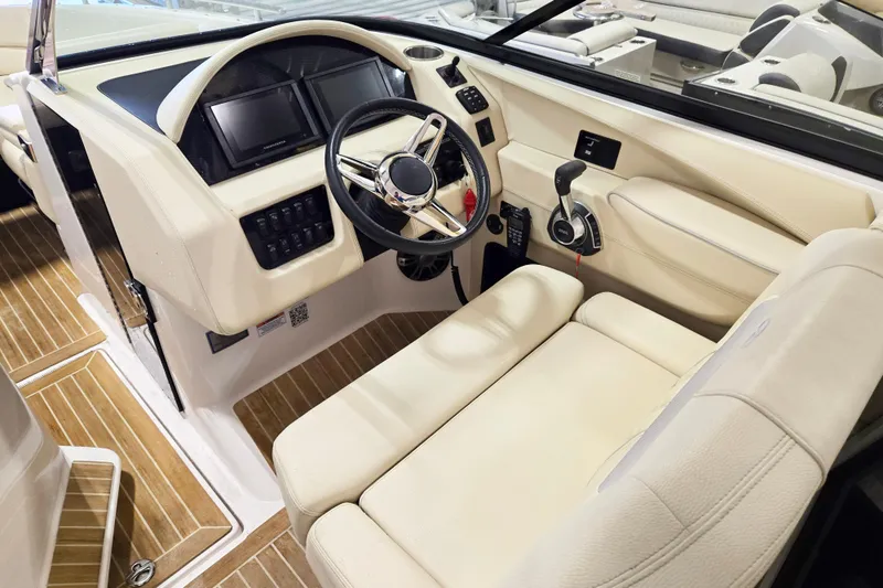 Slide: The Image of Interior of 2020 Regal 2800 Bowrider boat with modern dashboard and steering wheel. - 6