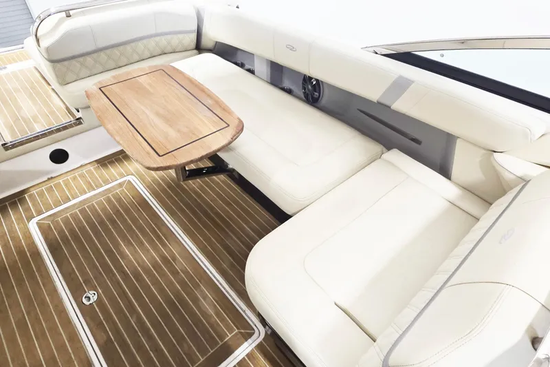 Slide: The Image of Luxurious interior of 2020 Regal 2800 Bowrider with elegant seating and wooden table. - 9
