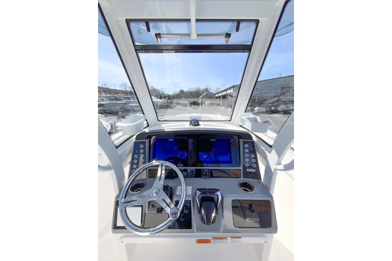 Slide: The Image of 2023 Robalo R270 Center Console helm with modern controls and navigation display. - 11