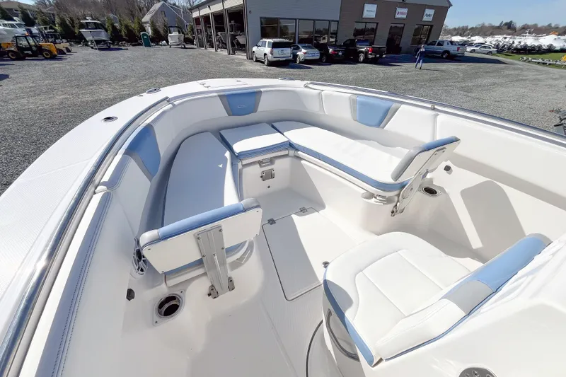 Slide: The Image of 2023 Robalo R270 Center Console boat interior with white and blue seating. - 12