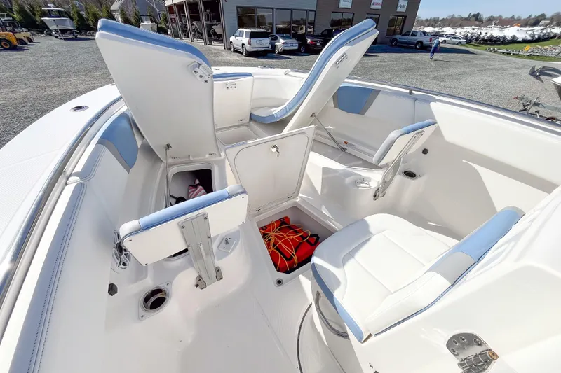 Slide: The Image of 2023 Robalo R270 Center Console boat interior with open storage compartments and seating. - 13