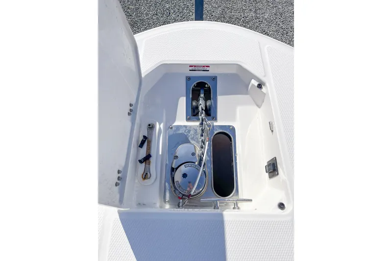 Slide: The Image of 2023 Robalo R270 Center Console anchor compartment with winch and chain storage. - 14