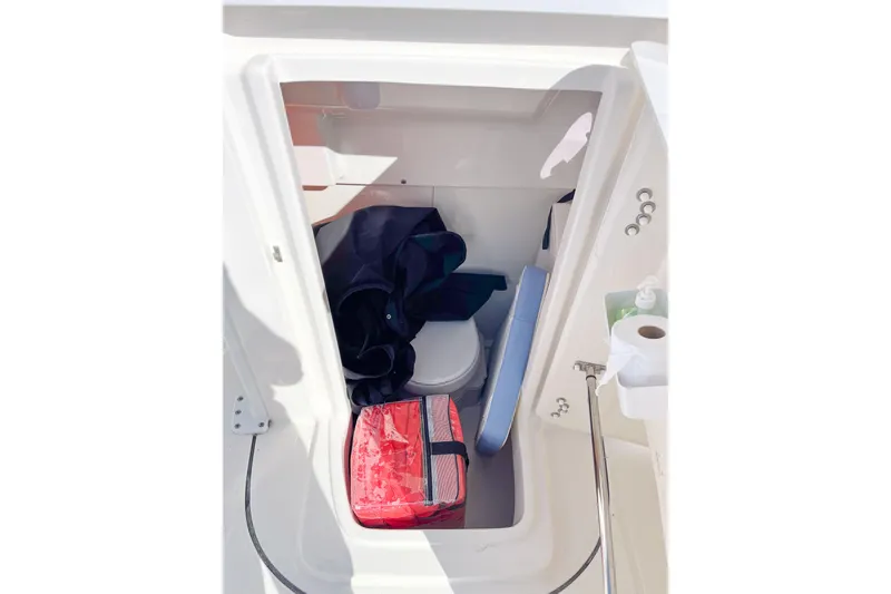 Slide: The Image of 2023 Robalo R270 Center Console interior storage with toilet and gear. - 16