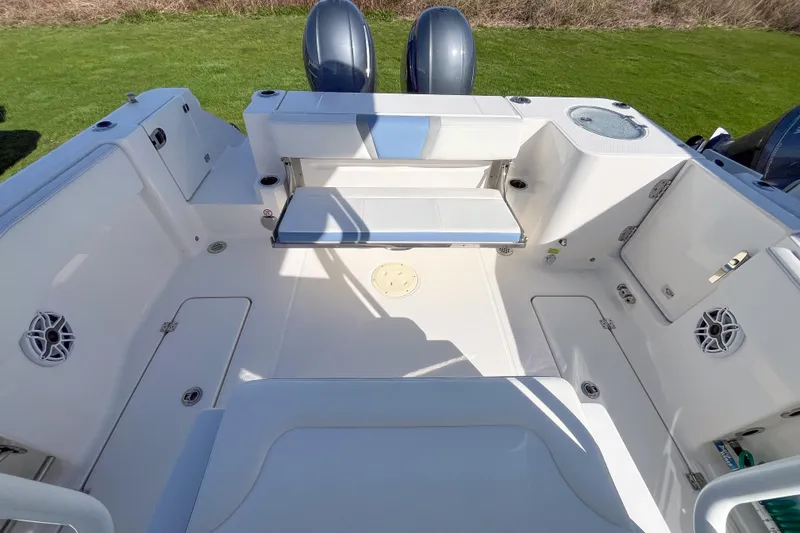 Slide: The Image of 2023 Robalo R270 Center Console boat interior with seating and storage compartments. - 4