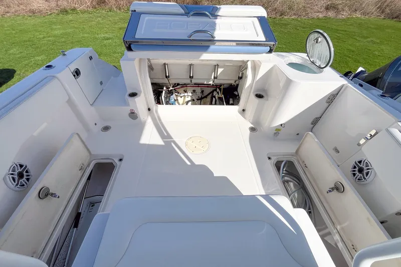Slide: The Image of 2023 Robalo R270 Center Console boat interior with open compartments and storage. - 5
