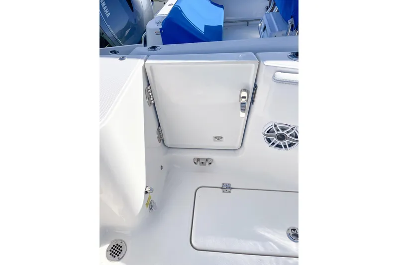 Slide: The Image of 2023 Robalo R270 Center Console boat interior with storage compartment and speaker. - 6