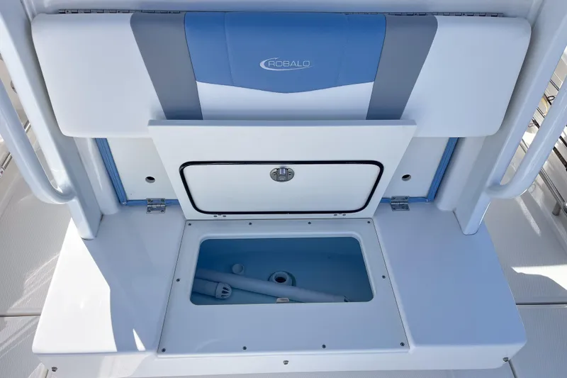 Slide: The Image of 2023 Robalo R270 Center Console storage compartment with open hatch, showcasing interior space. - 8