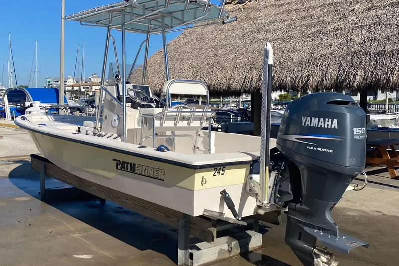 The Image of 2004 Pathfinder 2200 V boat with Yamaha 150 engine, docked near marina. - 0