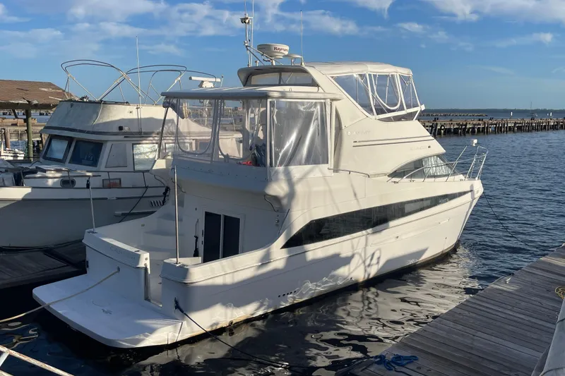 The Image of 2008 Carver 41 Cockpit Motor Yacht docked at marina under clear blue sky. - 0