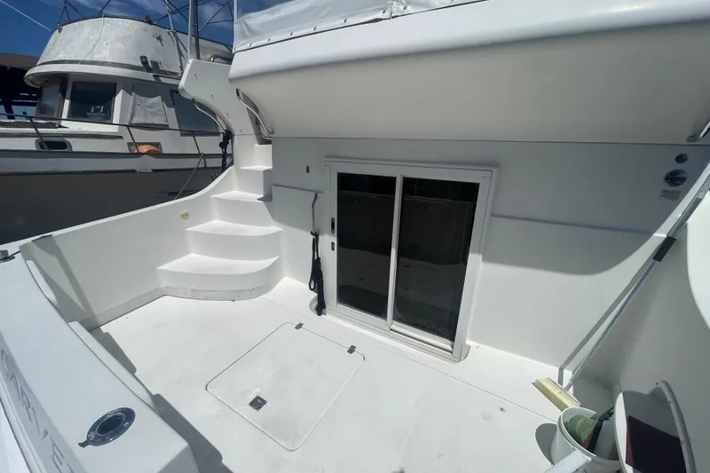 Slide: The Image of 2008 Carver 41 Cockpit Motor Yacht with white exterior and sliding glass doors. - 11