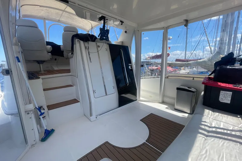 Slide: The Image of 2008 Carver 41 Cockpit Motor Yacht interior with seating and marina view. - 12