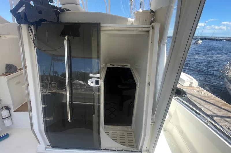 Slide: The Image of 2008 Carver 41 Cockpit Motor Yacht entrance with glass door, dockside view. - 13