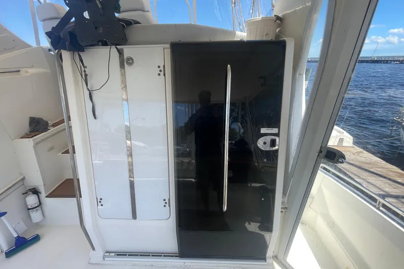 Slide: The Image of 2008 Carver 41 Cockpit Motor Yacht interior with glass door and water view. - 14