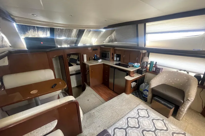 Slide: The Image of Interior of 2008 Carver 41 Cockpit Motor Yacht with kitchen and seating area. - 19