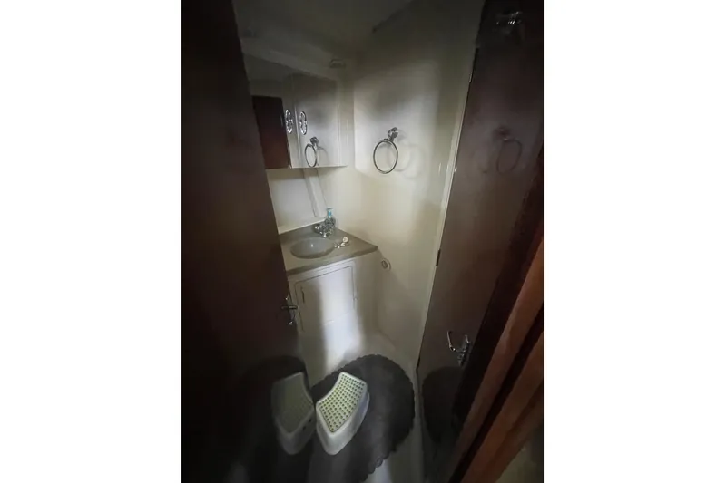 Slide: The Image of Compact bathroom in 2008 Carver 41 Cockpit Motor Yacht, featuring sink and storage. - 25