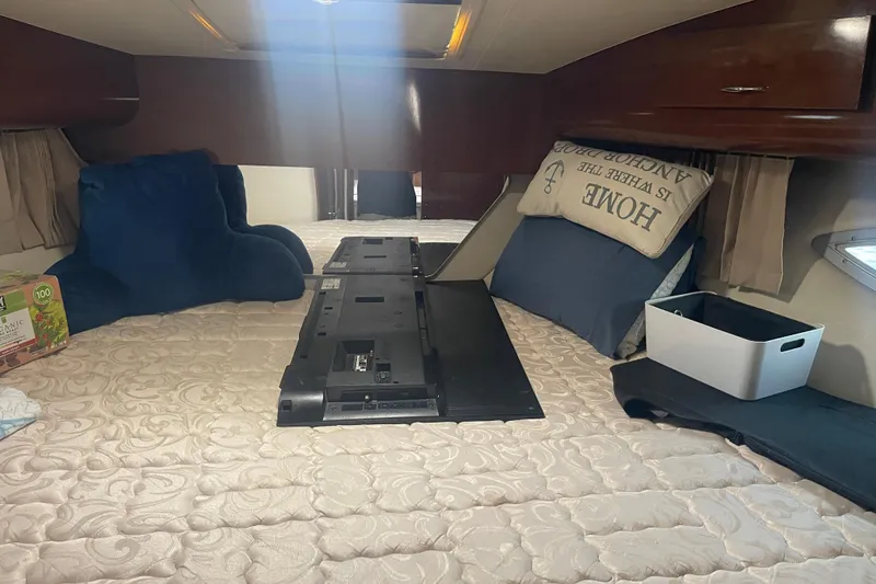 Slide: The Image of Interior of 2008 Carver 41 Cockpit Motor Yacht with cozy bedding and storage. - 27