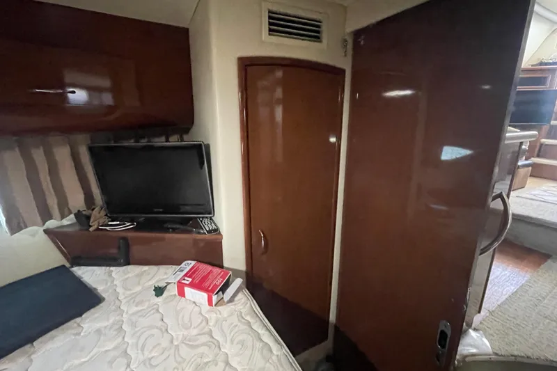 Slide: The Image of Interior of 2008 Carver 41 Cockpit Motor Yacht with TV and wooden cabinetry. - 28