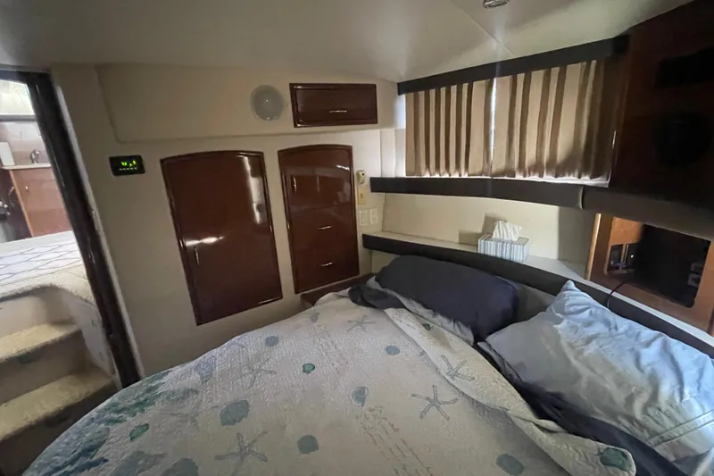 Slide: The Image of Cozy bedroom interior of 2008 Carver 41 Cockpit Motor Yacht with elegant wood cabinetry. - 33