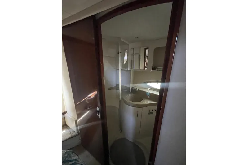 Slide: The Image of Interior view of 2008 Carver 41 Cockpit Motor Yacht bathroom with sink and mirror. - 34