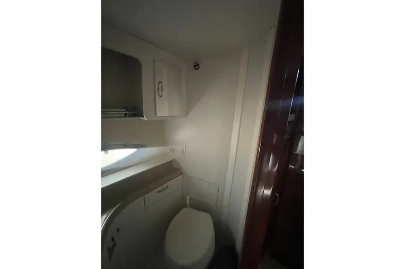 Slide: The Image of Bathroom interior of 2008 Carver 41 Cockpit Motor Yacht, featuring compact design and storage. - 37